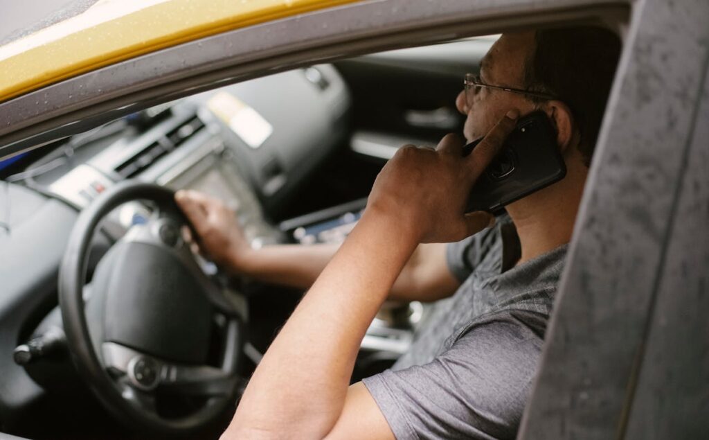 Photo by Tim Samuel: https://www.pexels.com/photo/focused-driver-speaking-on-smartphone-in-car-5835017/